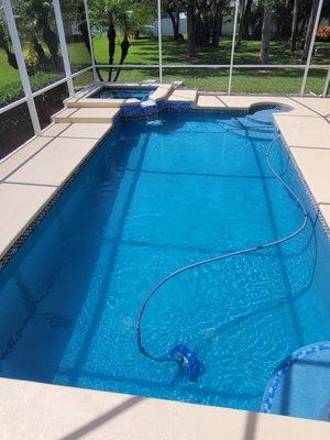Added Spa to the corner of the existing pool deck and steps to deck area, added spillover and Remodeled the deck with a flagstone design