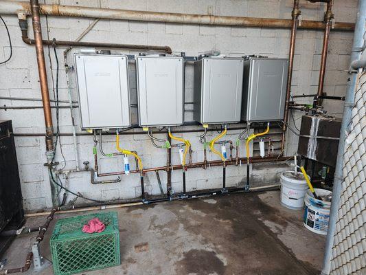 Four daisy chained tankless water heaters installed for a local laundry mat.