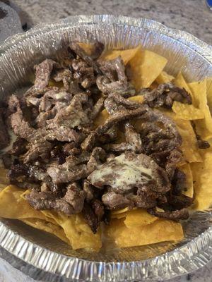 Steak nachos barely any cheese on it