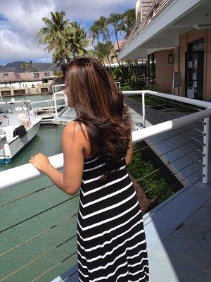 Medium chocolate base colour, dark caramel highlights,long layered cut with lots of texturizing finished with blowout.