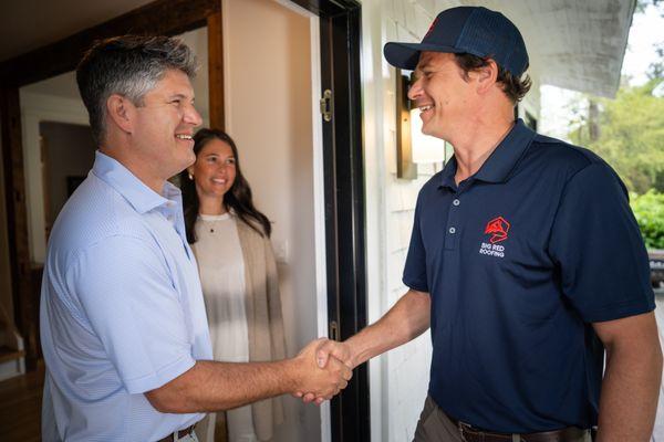 Shaking hands with the customer.