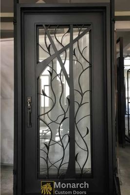Modern wrought iron door with glass and tree design. Durable, stylish, and secure.