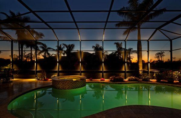 Sconce lights inside lanai creating an inviting mood at night.