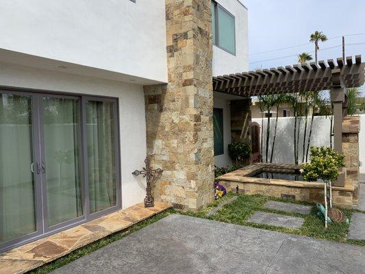 Custom water feature and Stamped cement with rock ascent.