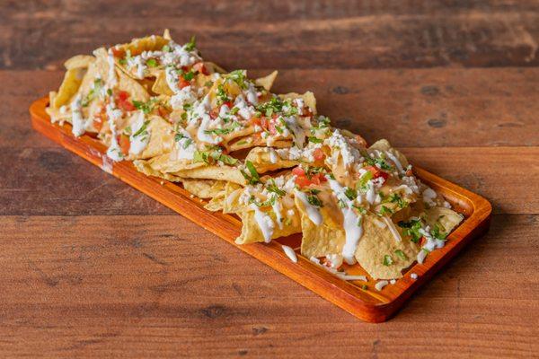 Nachos
Crisp tortilla chips layered with a blend of shredded Jack cheese and creamy queso cheese sauce, topped with fresh Pico de Gallo