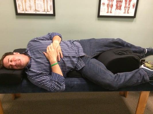 Demonstrating pillow Dr. Mark invented.