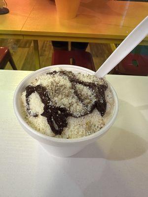 Corn in a cup topped with mayo, crema, queso cotija, and home made elote chile