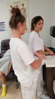 Students learning the proper way to wash their hands to prevent infection control.