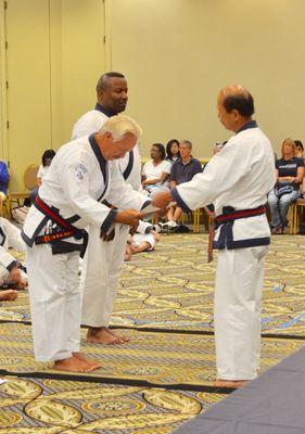 Master Brown receiving promotion to 8th Degree by Grandmaster HC Hwang