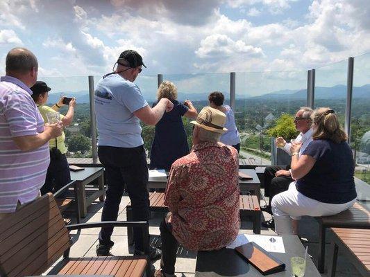 Asheville Rooftop Bar Tours photo. Showing you the history from the rooftops in Asheville, NC. Our company van takes you to each stop.