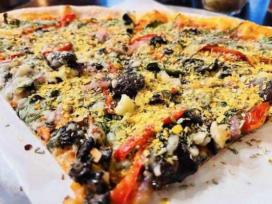 Heaven up close! Vegan vegetable pizza with brewers yeast from the table decanter!! Heavenly! (Is he dead yet?)