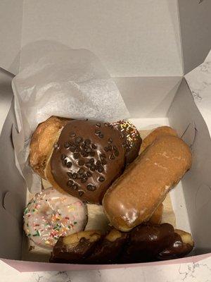 Chocolate chip roll, maple bar, vanilla cake with a few others hiding underneath