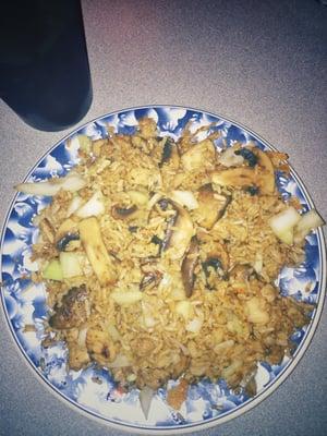 Mushroom fried rice with onions and chicken.