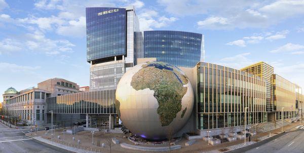 Exterior of the NC Museum of Natural Sciences, focused on the SECU Daily Planet, with the NEC to the left and NRC to the right.