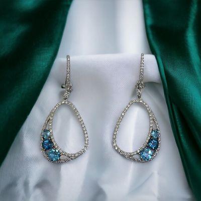 14kt White gold Diamond and Topaz earrings.