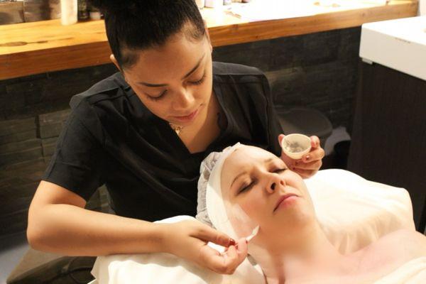 Applying an Aveda nourishing mask as part of the Amari Glo Deep Cleanse Facial.