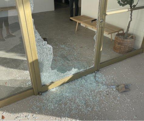 The front door of our building after someone threw a brick through it. Residents never received any sort of email about this.