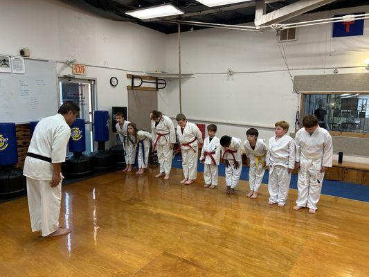 Sensei Magsombol bowing the kids in to start his class.