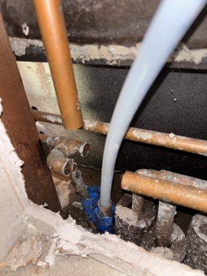 The PEX line fix exiting from the other side of the existing leaking copper pipe.