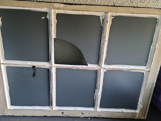 Back of broken mirrored window, which Wilson repaired quickly and reasonably.