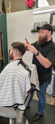 Husband getting his hair cut by Bryan.