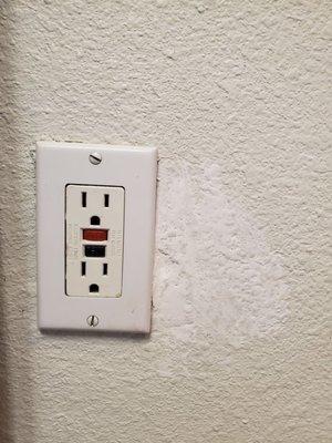 Filthy bathroom outlet cover and unfinished repair