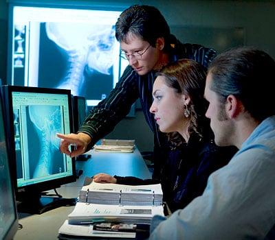 Students analyze digital x-rays of patients.