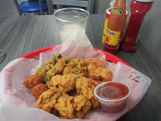 Shrimp and oysters with fried okra and hush puppies (I ordered garlic bread). About $17 with tax. Free Margarita.