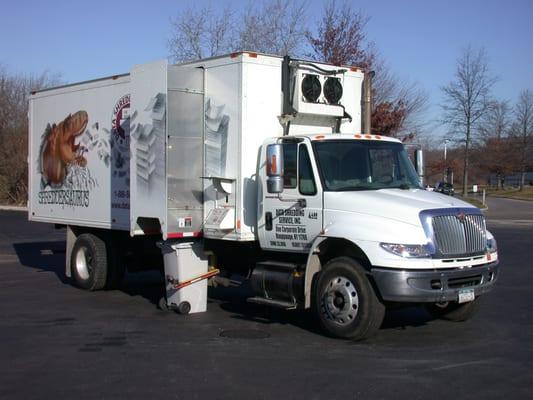 Shredding contents of a bin on-site