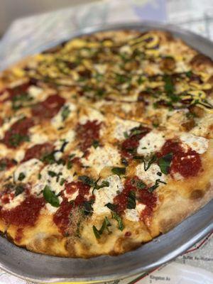 Half Margherita and half bbq chicken pizza