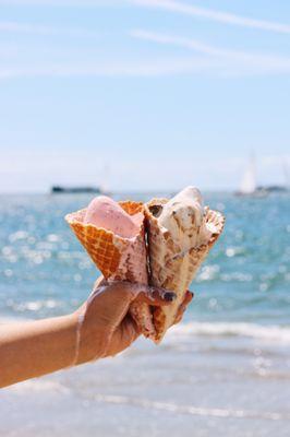 Two waffle cones with Strawberry ice cream and Caramel ice cream.