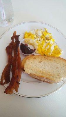 My scrambled eggs with toast and bacon.
