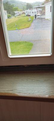 1 inch gap bottom of window frame. Insulation showing.