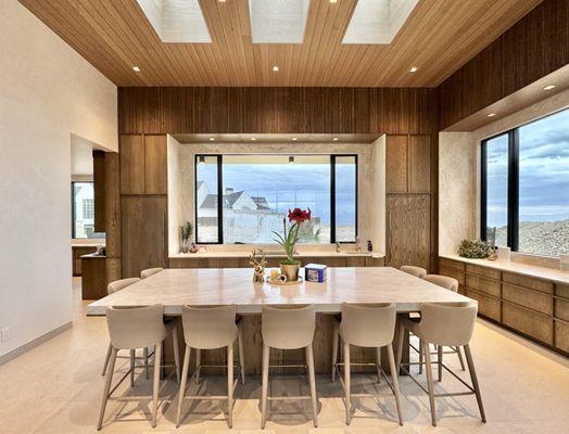 Modern custom kitchen with natural slated wood veneer fronts.