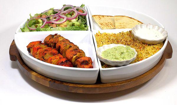 Chicken Kabob Plate -
Rice, 2 Skewers of Marinated Chicken Cubes, Salad, Chutney, and Pita
