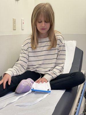 Not happy about her jammed finger so she was icing it while we waited