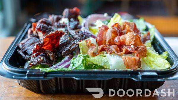 Dominican Blue Cheese Steak Salad - Romaine served with bacon,   blue cheese crumble, onions     and blue cheese dressing.