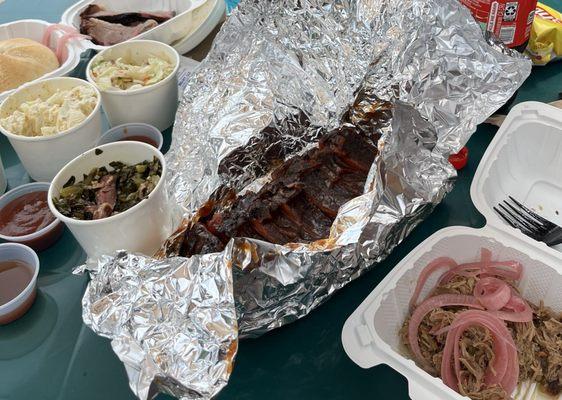 Pulled pork with pickles onions, half rack ribs, collard greens, potato salad, coleslaw.