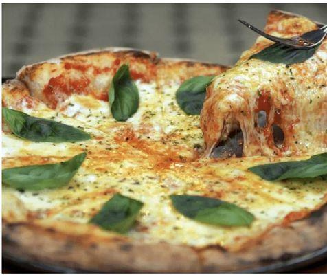 Cheese pizza and fresh basil