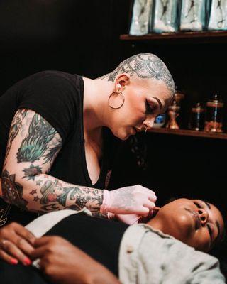 Our lead piercer,Becca, starting an ear curation on our client