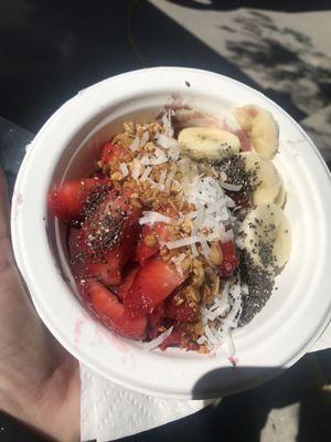 Açai bowl with strawberries, bananas, Açai smoothie, coconut, chia seeds, and granola with drizzled honey!