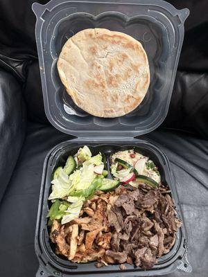 Shawarma chicken and beef over rice. Salad and humus with pita bread in to go plate.