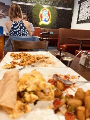 An omelette w/ cheese and spinach and a chorizo w/eggs plate.
