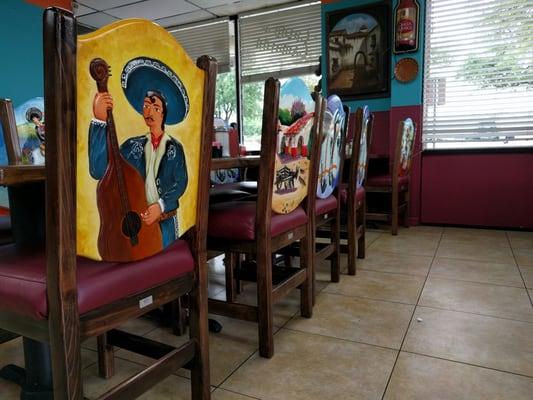 Beautifully decorated chairs with scenes of everyday life in Mexico