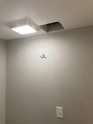 Jagged hole cut in the bathroom ceiling
