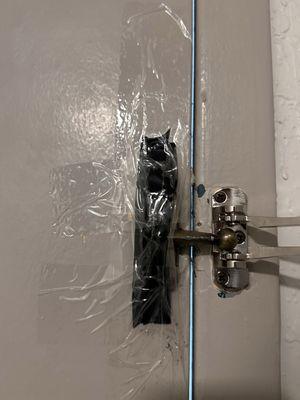 Well, that's a safety bracket and the base of it is taped to the door.