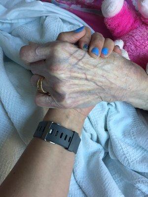 My grandmother holding my hand, and wearing her ring on my last visit with her before her passing.