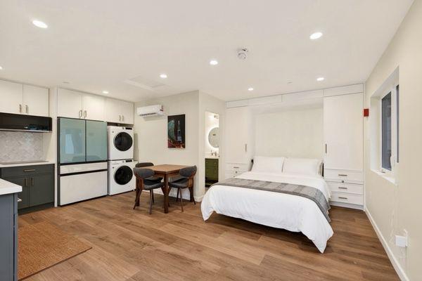 Murphy bed, fridge, and laundry center.