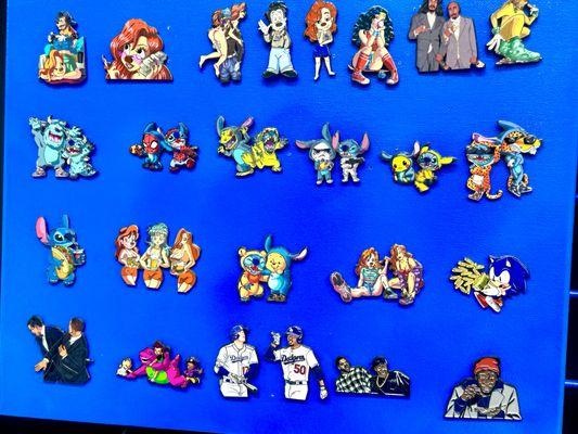 A collection of 2" enamel pins featuring original hand-drawn mashups of cartoons, hip-hop, and pop culture icons.