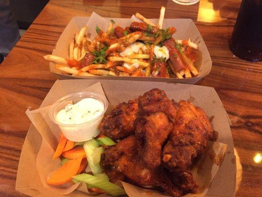 Spicy Sriracha Hawaiian Fries on top. Chicken Wings with Carolina Reaper Sauce on the bottom.